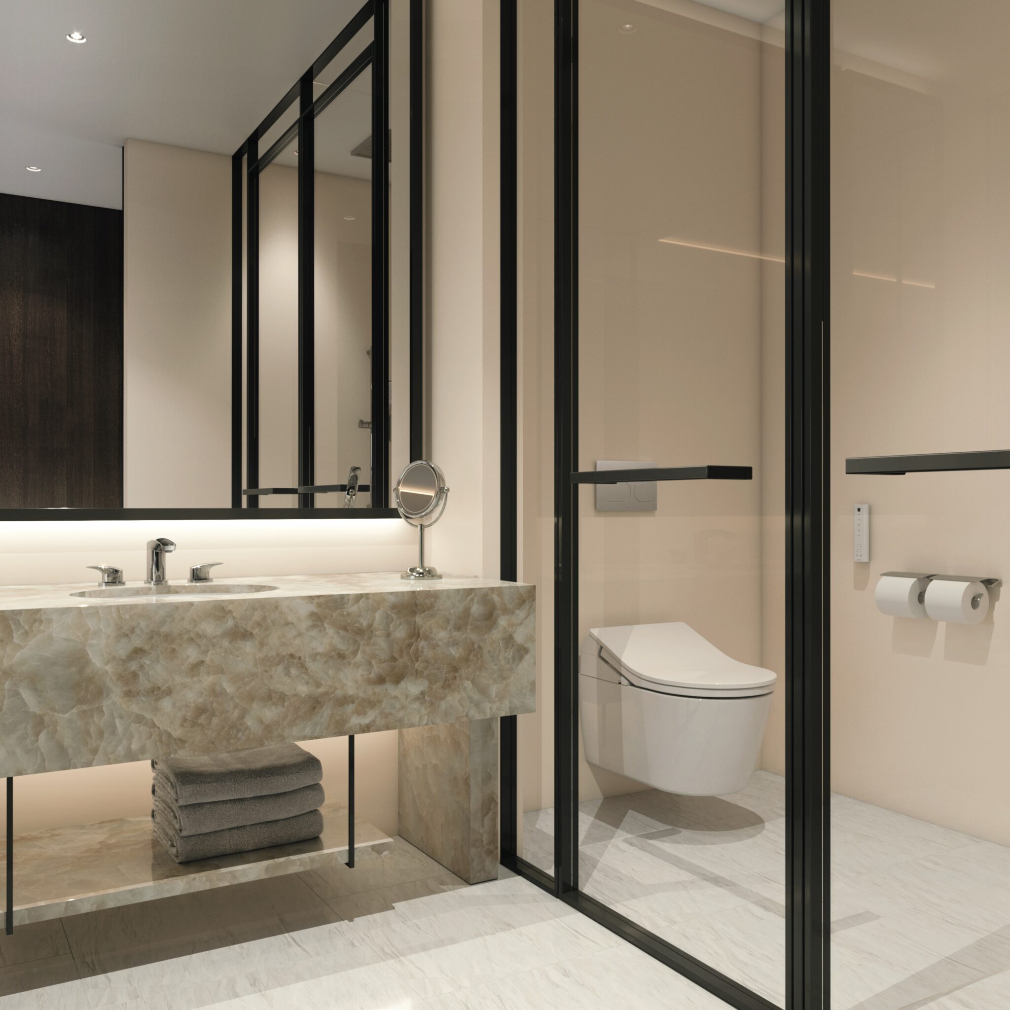 Modern bathroom with marble countertop, dual sinks, and folded towels below. Glass enclosure reveals a sleek toilet. Bright, minimalist design.