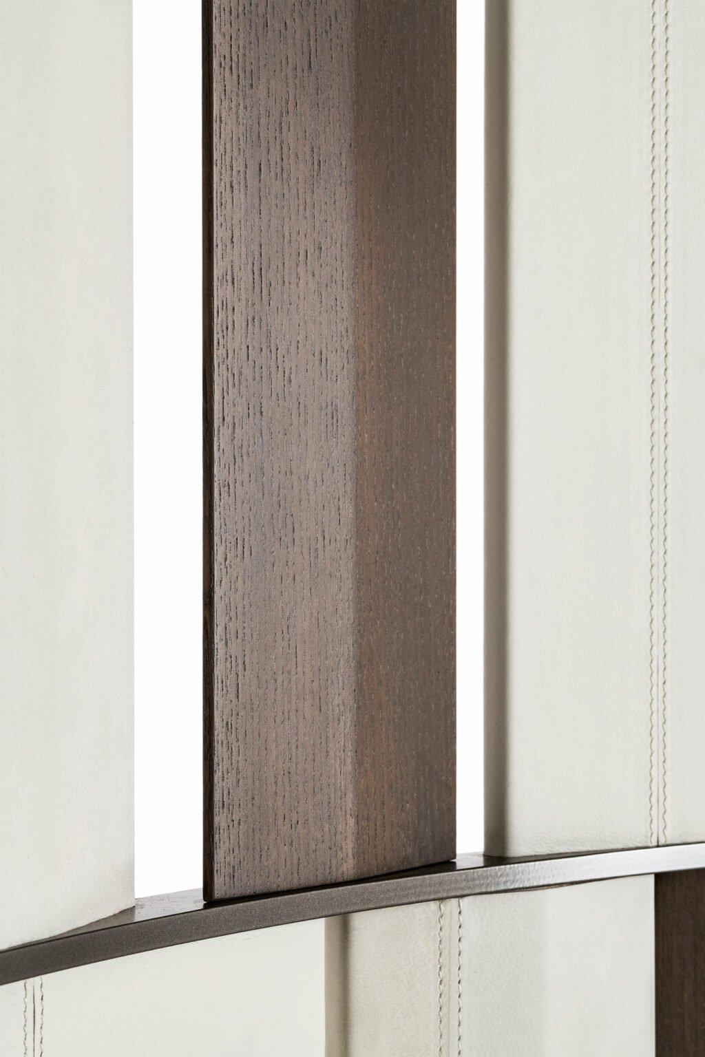 Close-up of a a three-panel room divider with vertical beige and brown panels arranged in an alternating pattern. The metal frame gives a modern, elegant look.