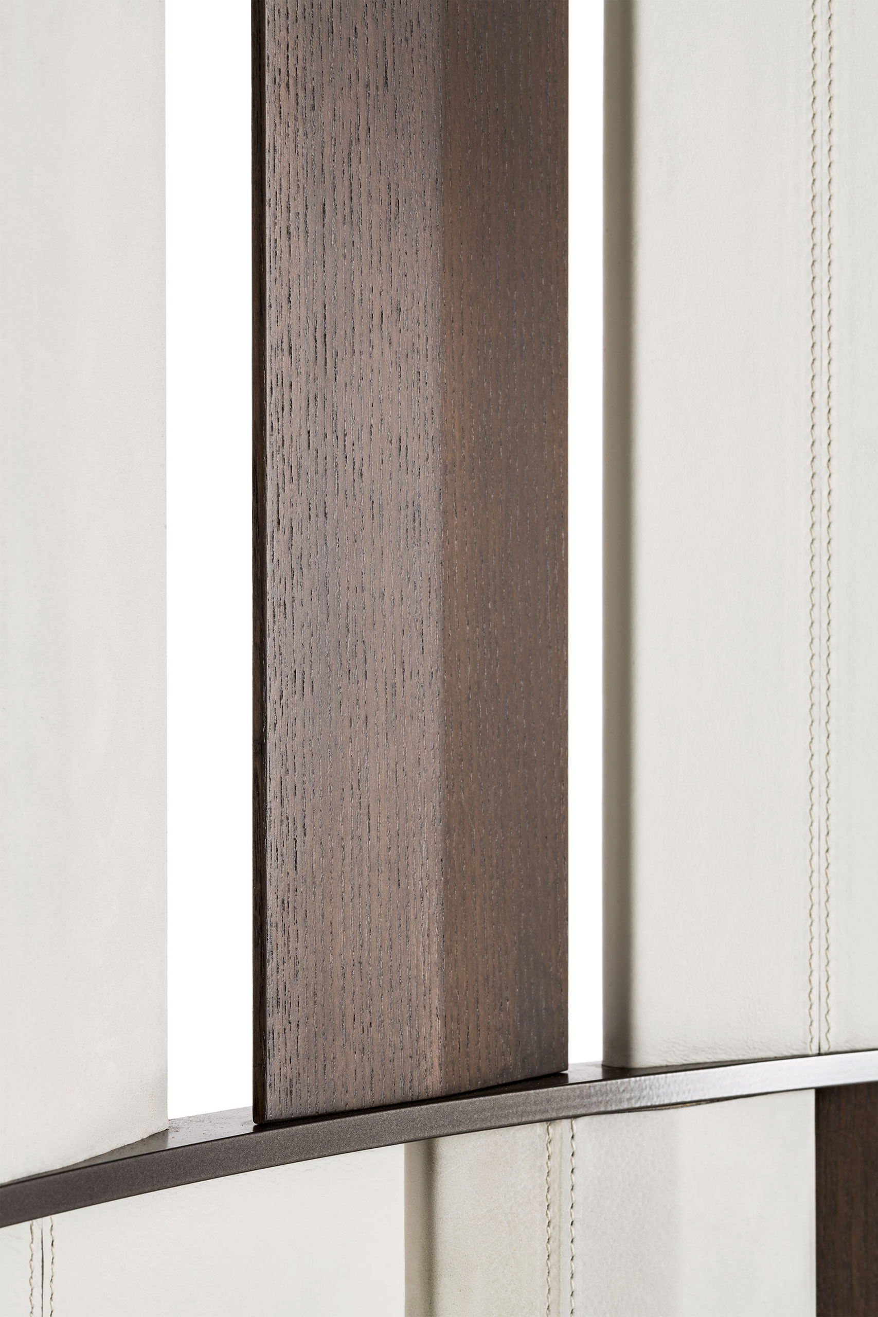 Close-up of a a three-panel room divider with vertical beige and brown panels arranged in an alternating pattern. The metal frame gives a modern, elegant look.