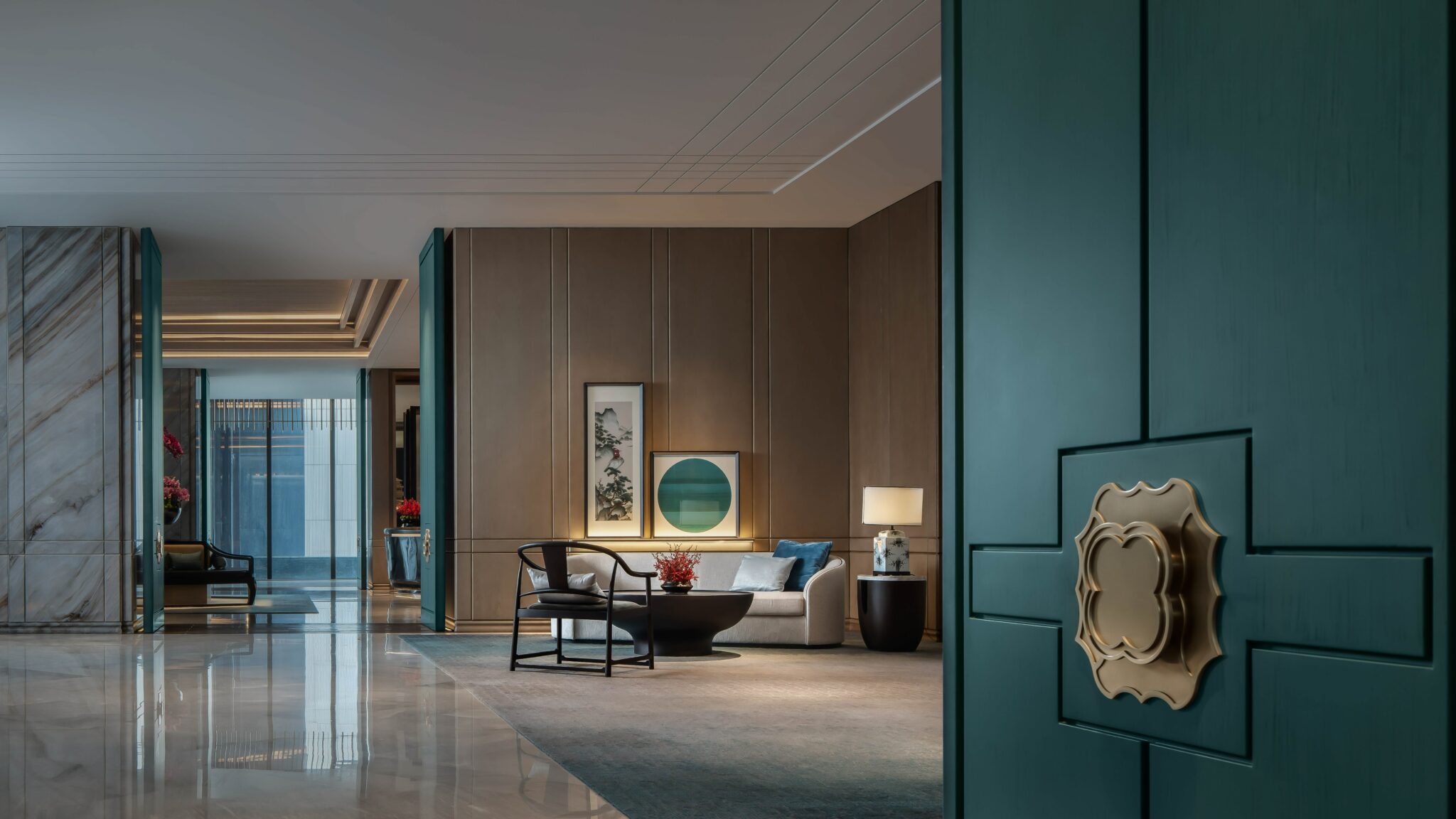 Luxurious hotel lounge with teal double doors, elegant furniture, modern art, soft lighting, and a tranquil ambiance.