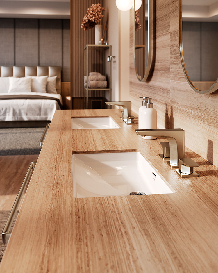 Modern bathroom with a light wood double vanity, chrome faucets, and oval mirrors. Towels and decor in the background create a warm, inviting atmosphere.