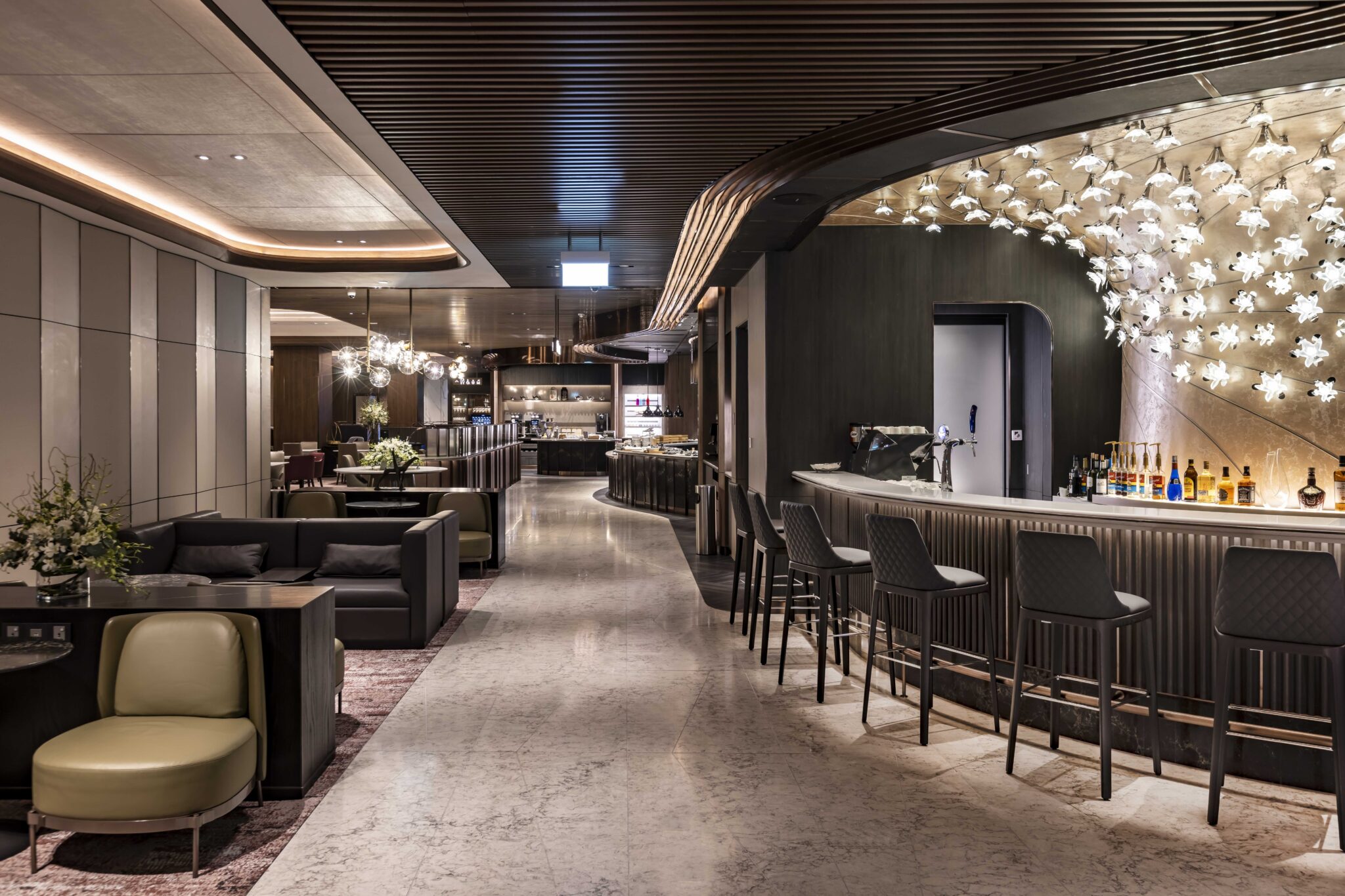 An elegant bar and lounge area featuring stylish seating, a sleek bar counter, and artistic lighting, creating a sophisticated ambiance for guests to unwind and socialize.
