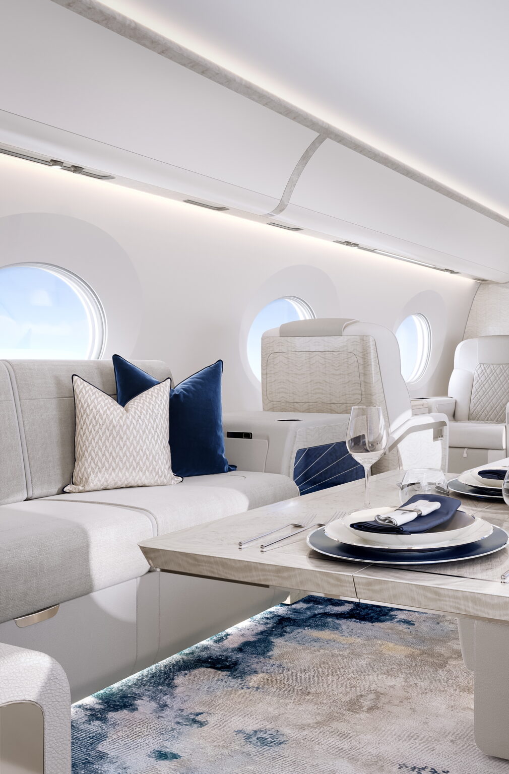 The interior of a private jet, designed in light grey upholstery and blue accents.