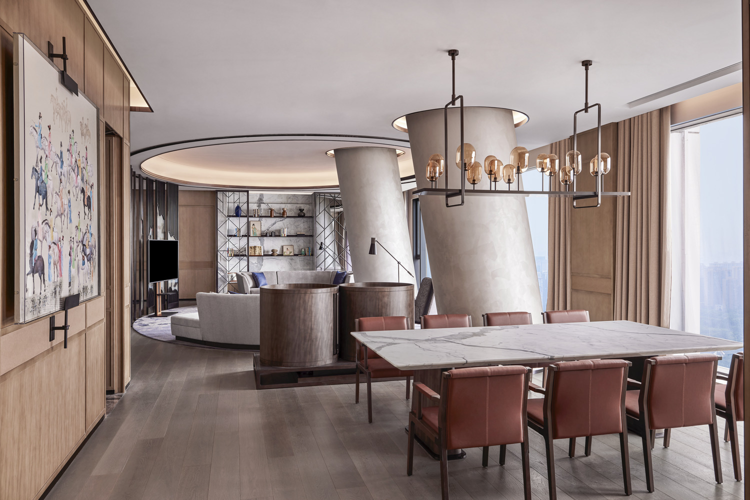 A hotel suite featuring a marble dining table, burnt orang chairs and architectural concrete pillars.