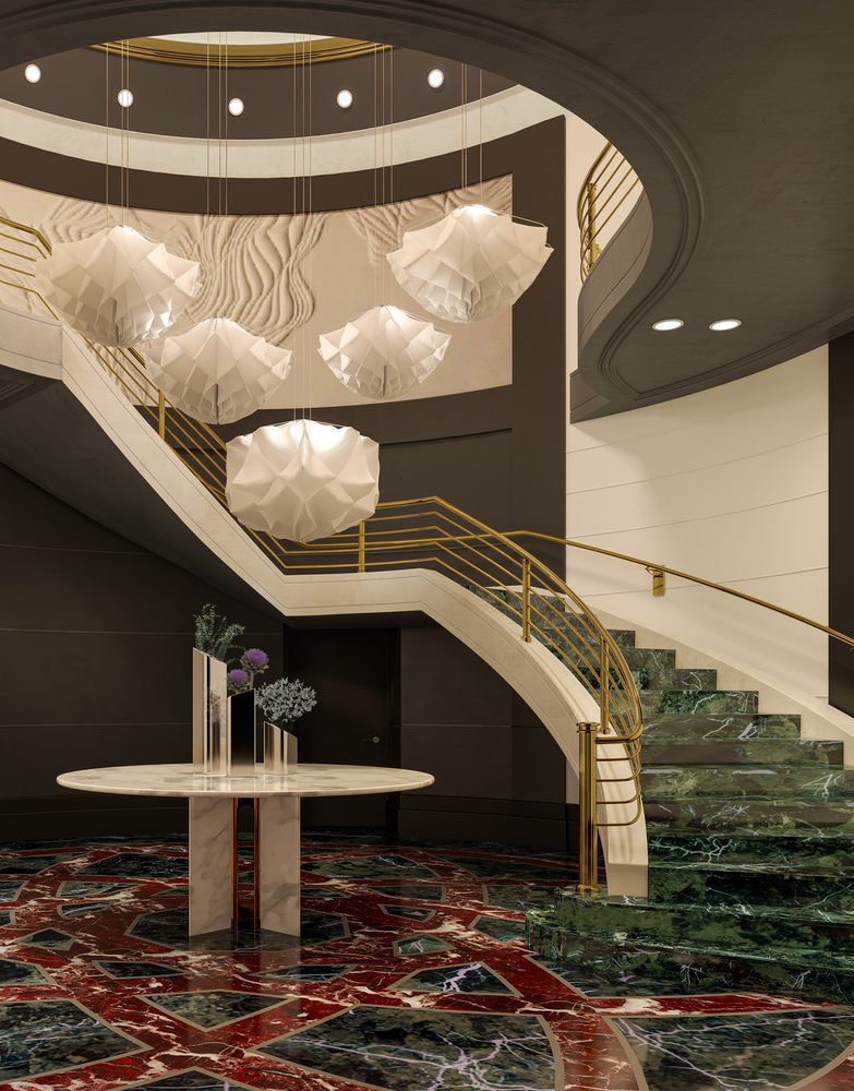 A sweeping staircase with green marble steps and golden railings rises beneath sculptural pendant lights and a dramatic marble floor inlay.