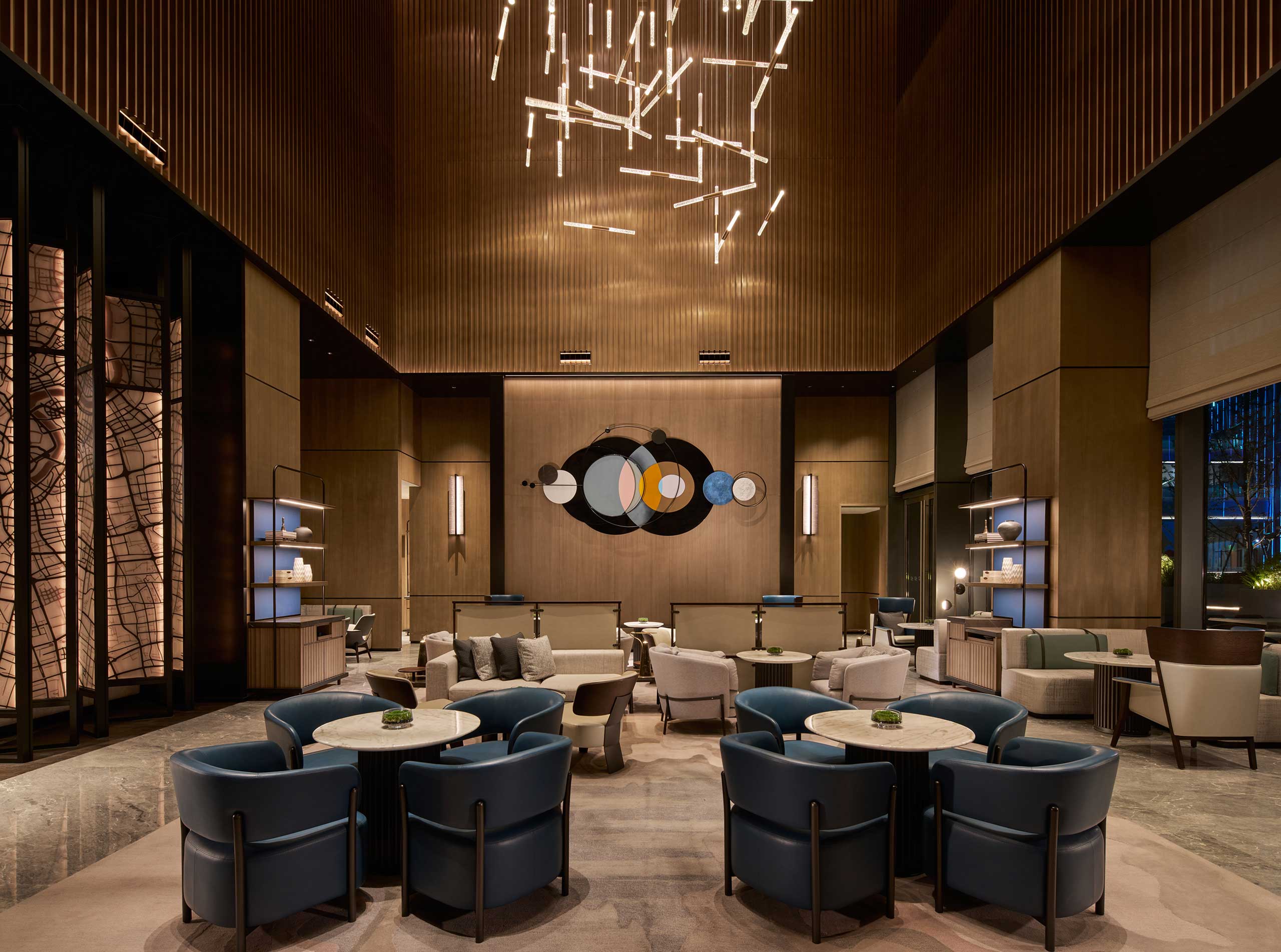 Hilton Shanghai Zhangjiang Science City lobby lounge with modern seating, artistic wall décor, and contemporary chandelier lighting.