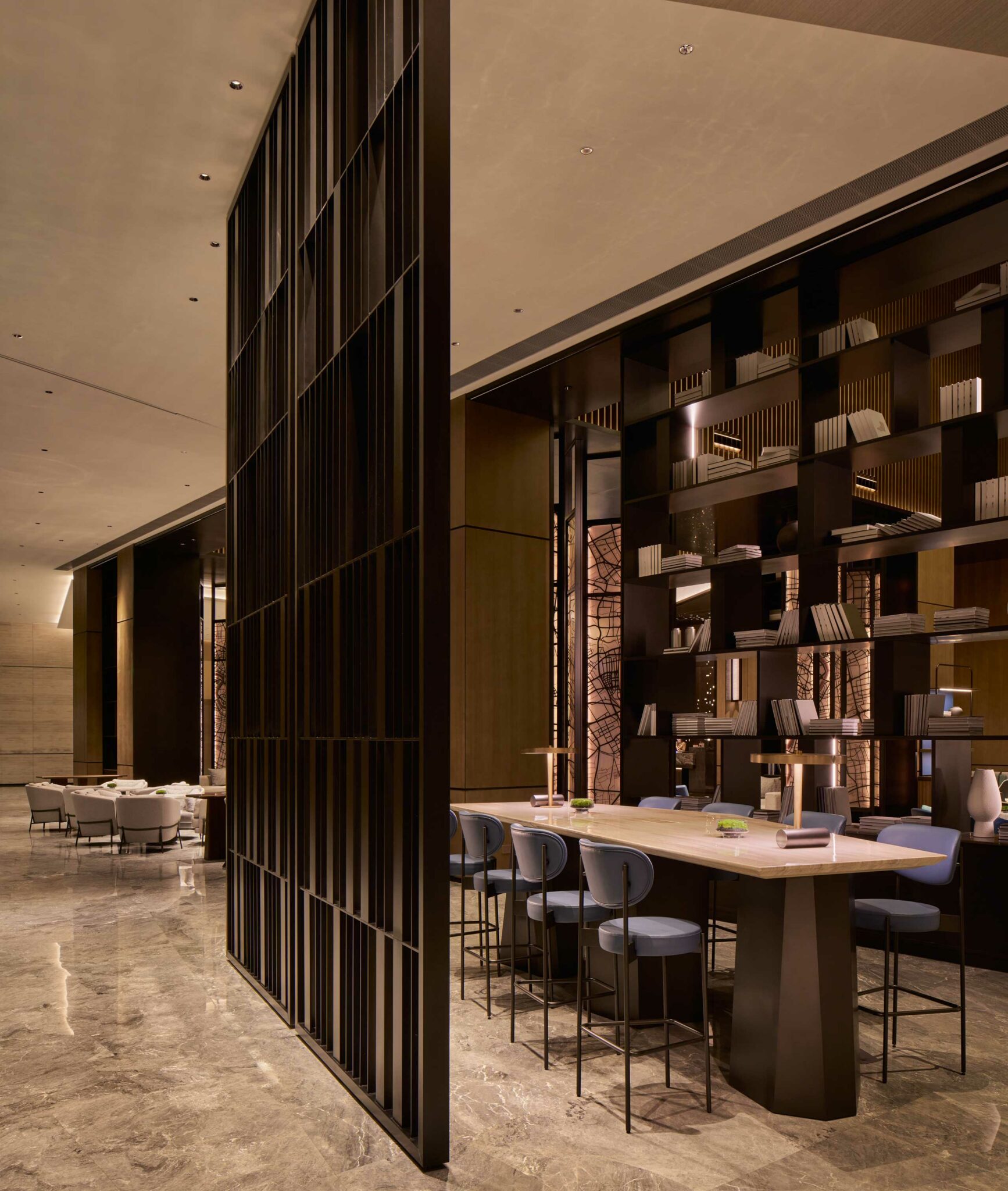 Hilton Shanghai Zhangjiang Science City lobby lounge with modern high-top seating, open bookshelf partition, and contemporary interior design