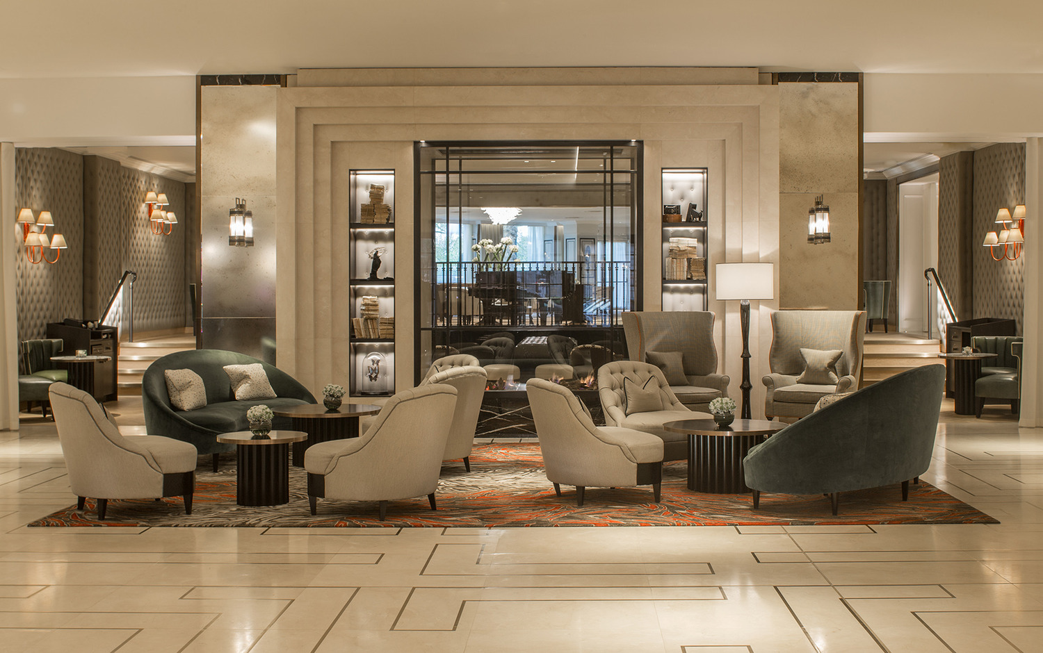 Elegant restaurant interior with tufted banquette seating, round tables set for afternoon tea, and striking mirrored ceiling with sculptural chandeliers.*