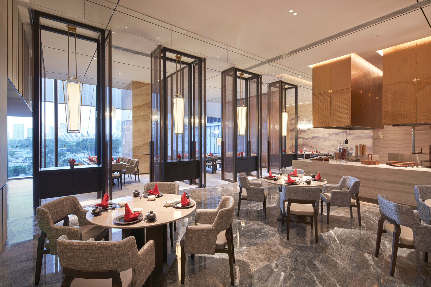 Elegant modern restaurant interior within a luxurious resort featuring geometric ceiling lights, wooden floors, and stylish beige chairs around round tables, creating a warm, inviting ambiance.