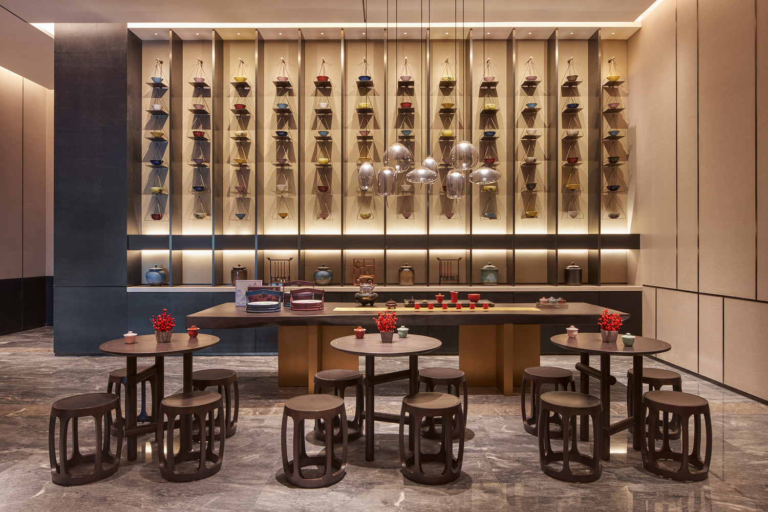 Elegant modern restaurant interior within a luxurious resort featuring geometric ceiling lights, wooden floors, and stylish beige chairs around round tables, creating a warm, inviting ambiance.