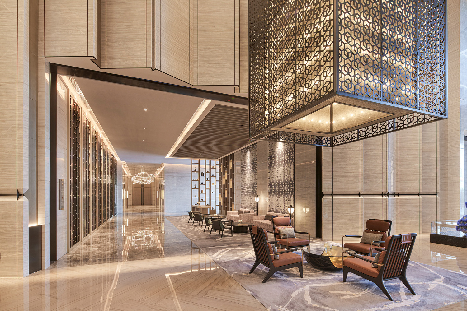 Modern hotel lobby with a sleek marble reception desk, vibrant teal and red shelving, elegant lighting, and a lush indoor tree. The space conveys luxury.