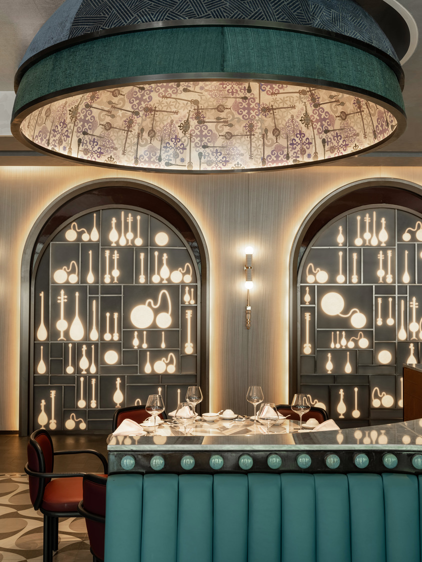 Luxurious hotel lobby with high ceiling and string lights. Features elegant sofas, coffee tables, and potted trees. Airy and sophisticated ambiance.