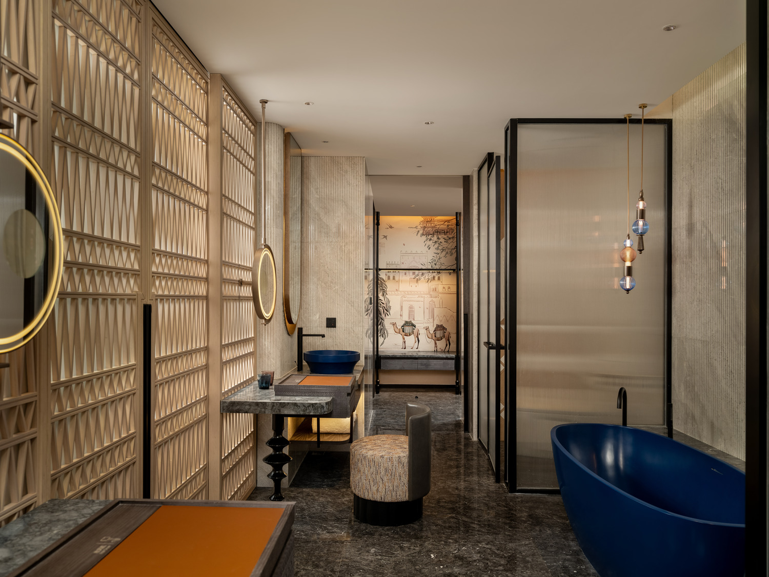 Luxurious hotel suite with modern decor, featuring a plush bed, abstract art, a large TV, and elegant seating. Warm lighting creates a cozy ambiance.