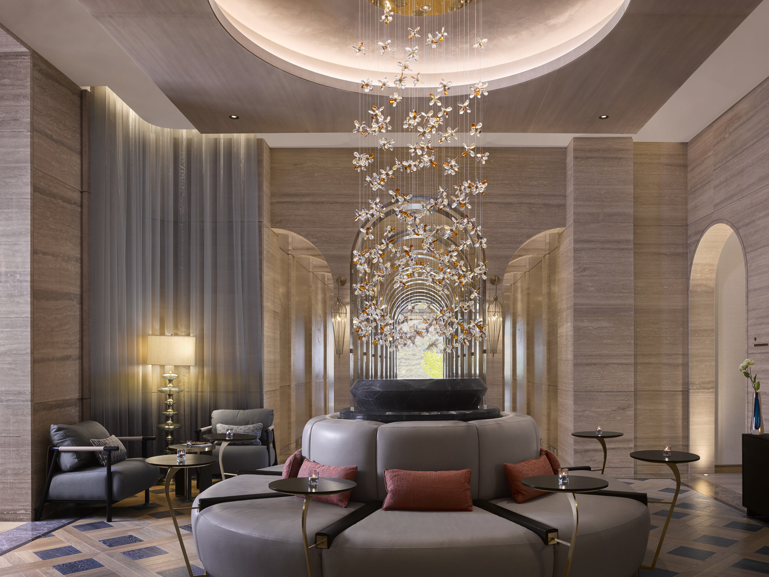 Luxurious resort spa interior with arched golden doorways and marble walls. A person in a white robe walks through the opulent, serene hallway.