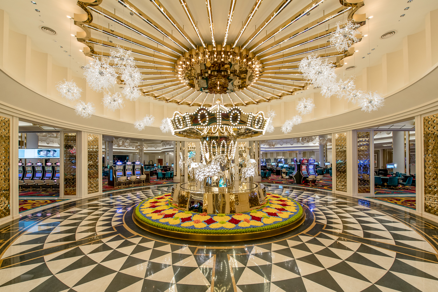 A vibrant casino interior featuring luxurious chandeliers, colorful slot machines, and stylish gaming tables, creating an energetic and glamorous atmosphere for guests seeking entertainment and excitement.