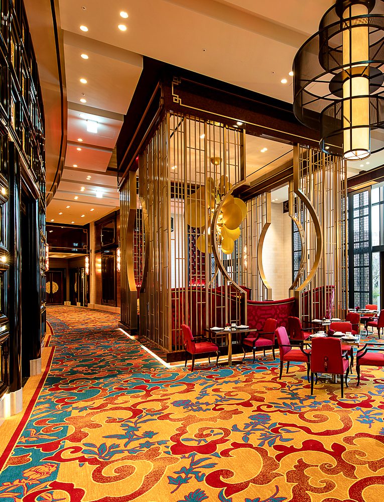 A vibrant casino interior featuring luxurious chandeliers, colorful slot machines, and stylish gaming tables, creating an energetic and glamorous atmosphere for guests seeking entertainment and excitement.