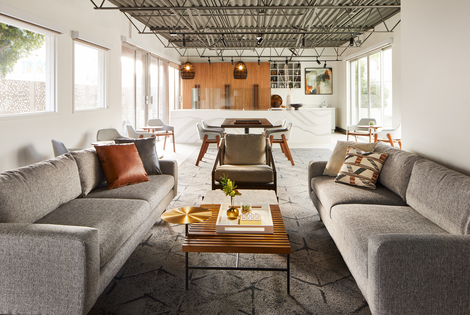 Lobby lounge with modern sofas, marble coffee tables, wood panel walls, and luxury interior design