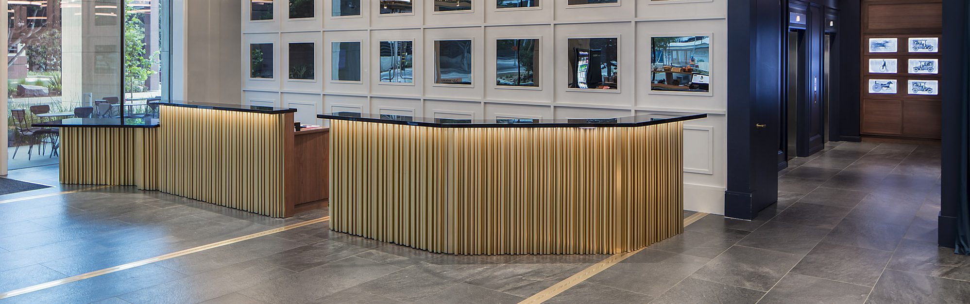 Hotel Indigo Los Angeles Downtown lobby and reception, brass reception desks with ring pendant chandeliers, luxury hotel interior design by HBA