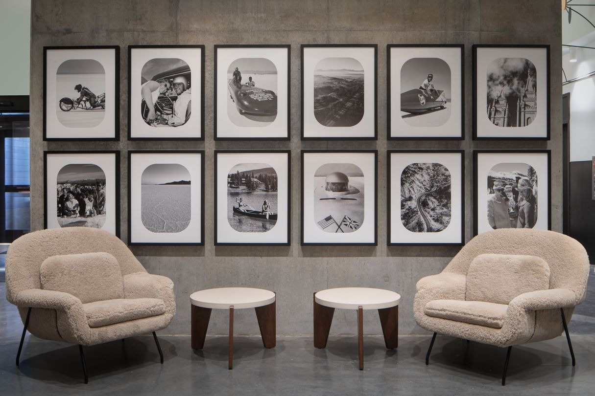 elegant hotel lounge with dim lighting, featuring round tables, plush chairs, and a sleek bar in the background. The ambiance is cozy and sophisticated.