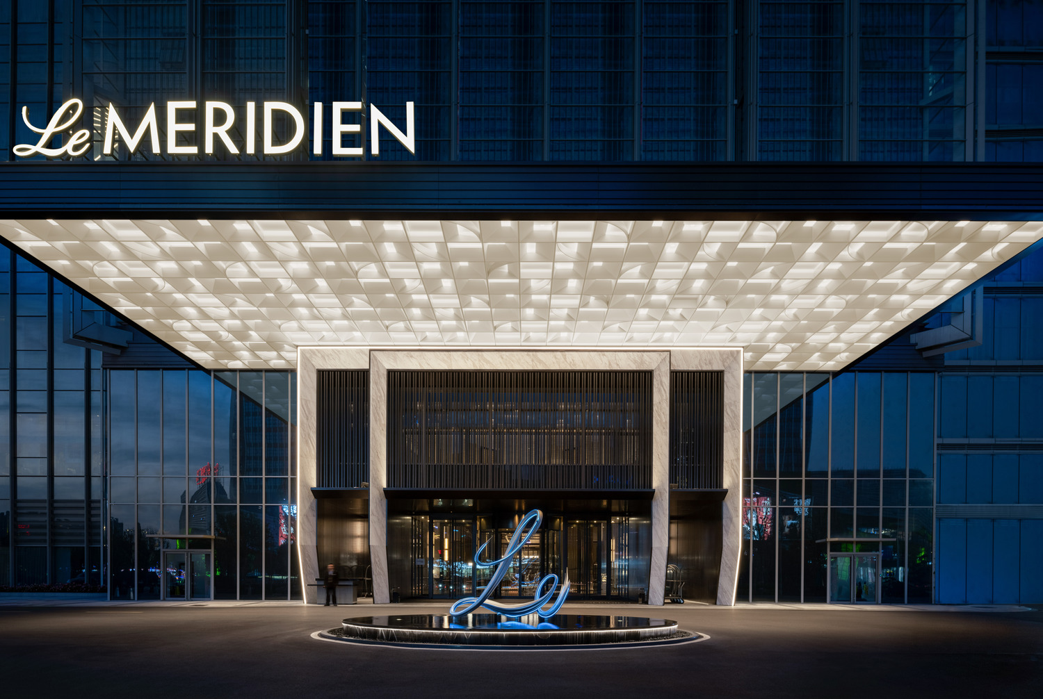 Elegant hotel entrance with dark iron and grey stone.