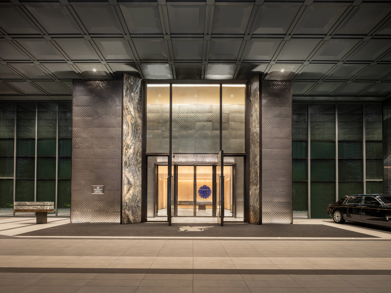 Elegant hotel entrance with dark iron and grey stone.