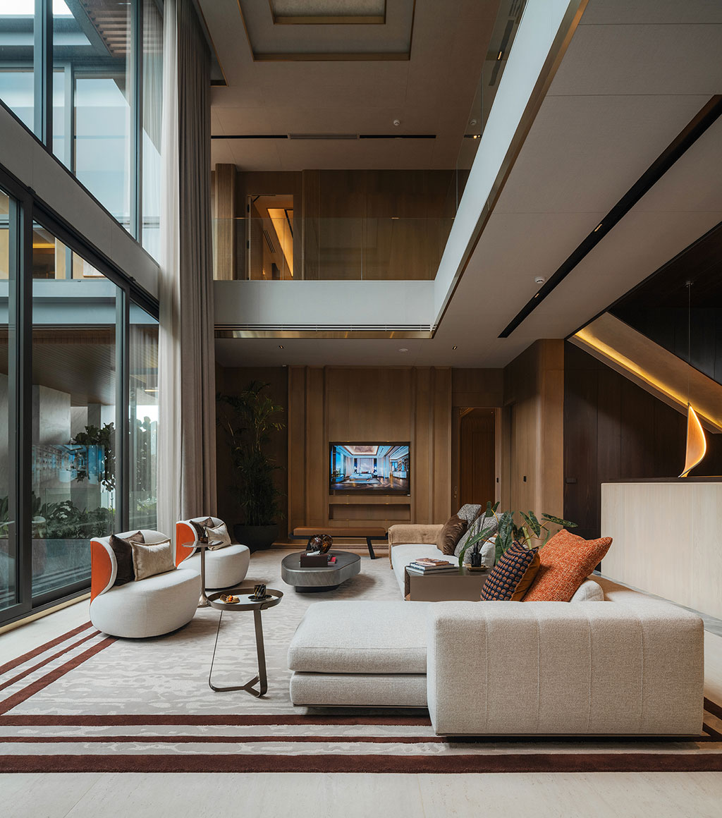 Modern living room with high ceilings, large windows, and stylish furniture. A neutral color palette creates a calm, sophisticated atmosphere.