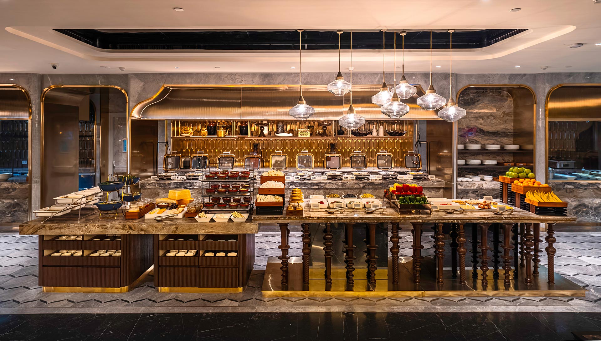 Luxurious buffet setup with elegant lighting, showcasing a variety of foods including pastries, fruits, and breads on marble tables, creating a lavish dining ambiance.