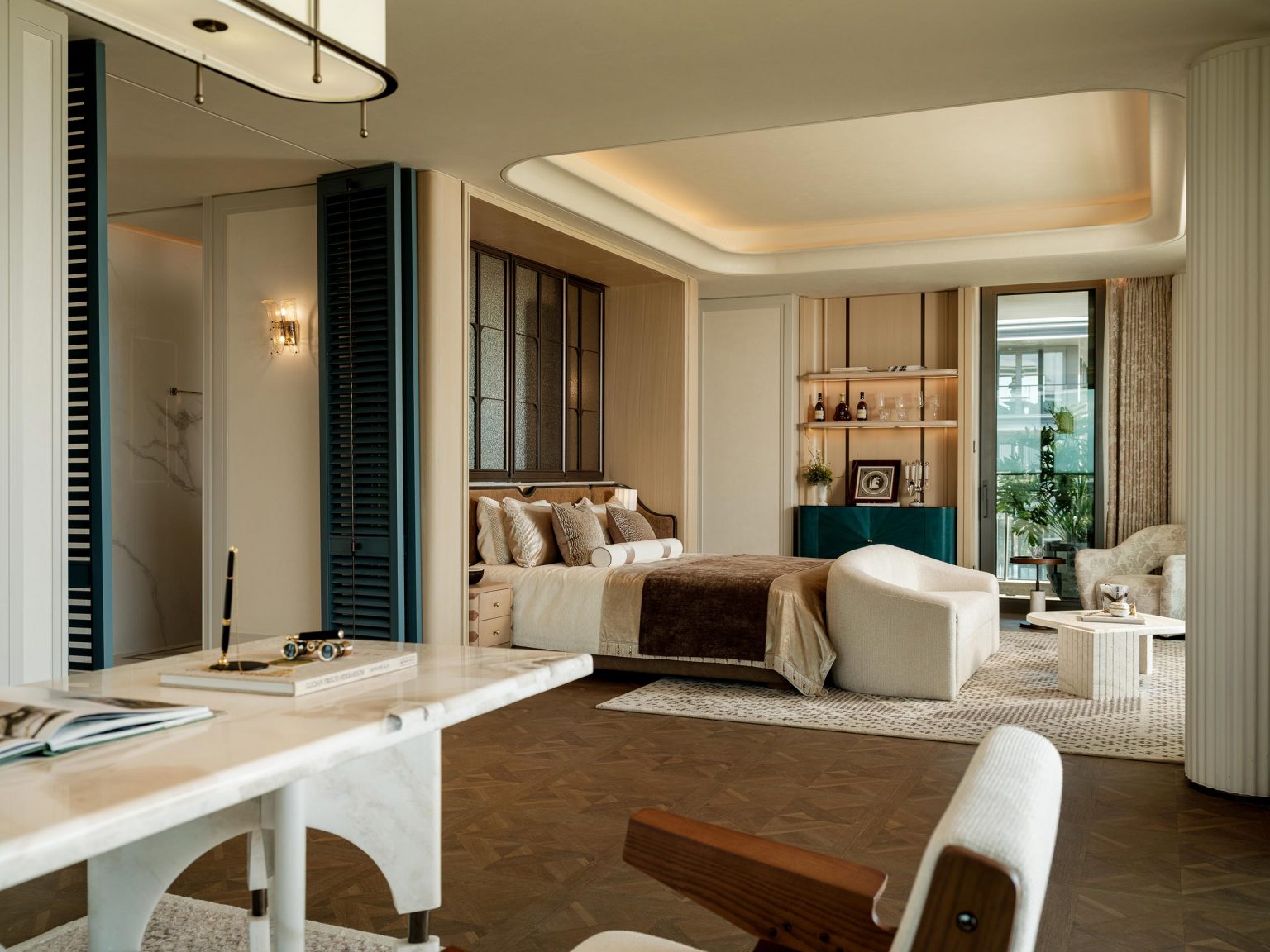 Luxurious bedroom with elegant modern decor, featuring a plush bed, cozy seating, marble table, and warm lighting. A window opens to a green view.