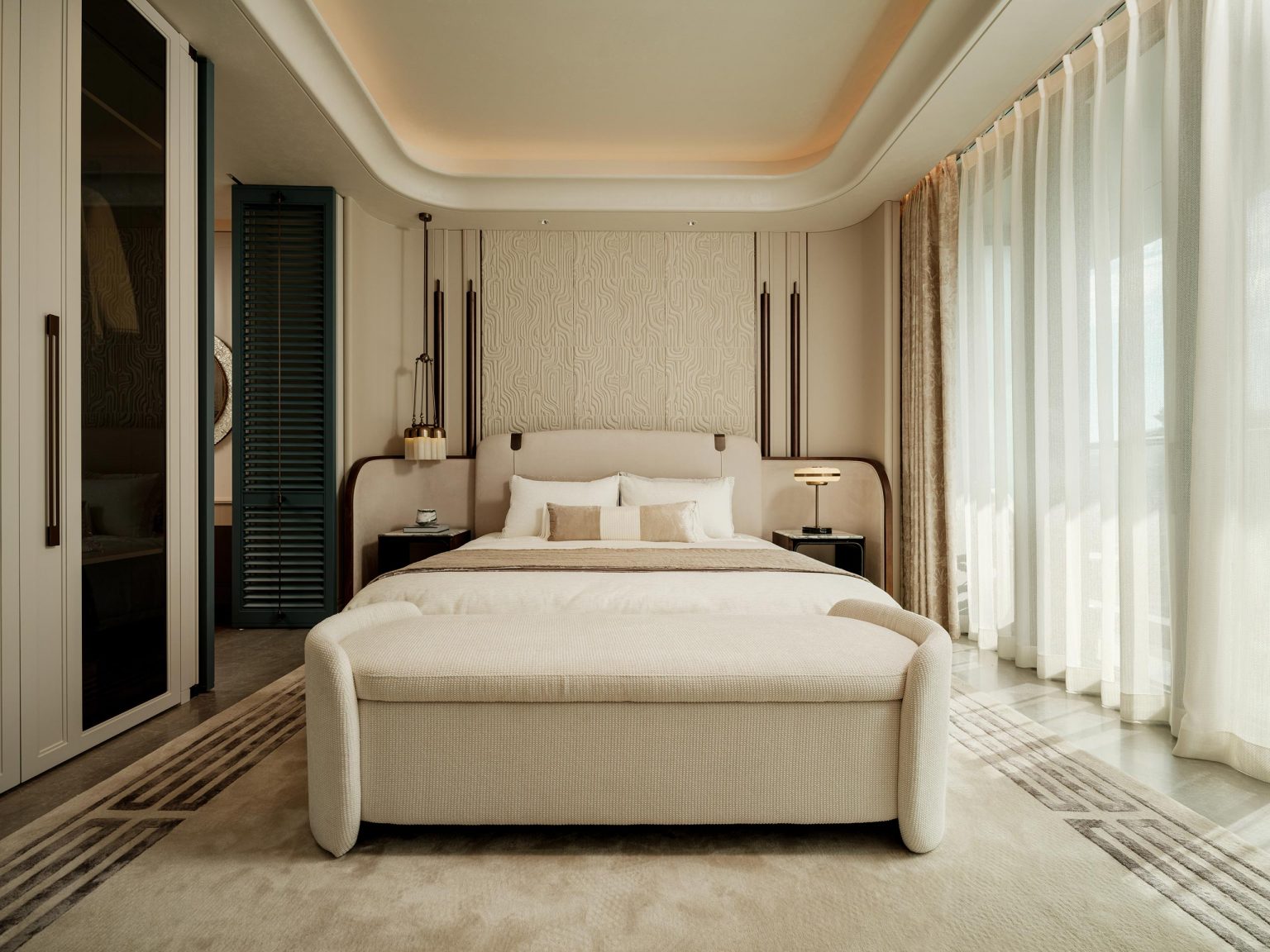 Elegant bedroom with a large, cushioned bed centered. Soft lighting, floor-to-ceiling curtains, and warm tones create a serene, luxurious atmosphere.